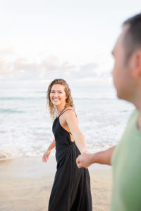 girl walking couple on Hanalei Beach engagement photoshoot