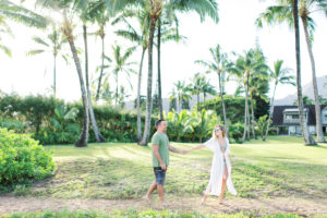 Kauai engagement photo shoot couple walking Hanalei Bay