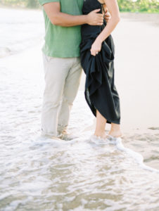 film photographer couple feet in water Hanalei Beach engagement photoshoot