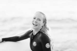 surfer girl with board in rip curl wet suit